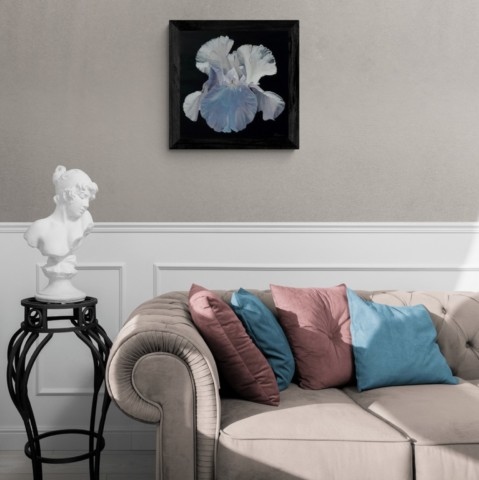 Painting of a white iris displayed in a living‑room setting by wildlife artist Laurence Saunois.