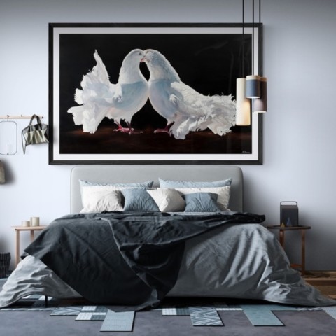 “Painting of white pigeons displayed in a bedroom setting above a bed by wildlife artist Laurence Saunois