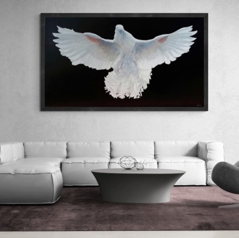 Large painting of a white pigeon with its wings spread, displayed in a living‑room setting above a white sofa by wildlife artist Laurence Saunois.