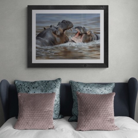  Framed painting of playing hippos in a setting above a bed
