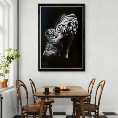 Painting of a tigress with her cub displayed in a dining‑room setting by wildlife artist Laurence Saunois